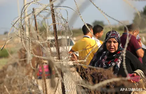 Palestinians wait for travel permits to cross into Egypt through the Rafah border crossing after it was opened by Egyptian authorities for humanitarian cases, in Rafah in the southern Gaza Strip on August 16, 2017. Photo...