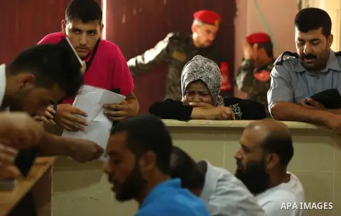 Palestinians wait for travel permits to cross into Egypt through the Rafah border crossing after it was opened by Egyptian authorities for humanitarian cases, in Rafah in the southern Gaza Strip on August 16, 2017. Photo...