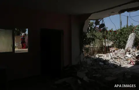 A woman walks next to the remains of the family house of Palestinian assailant Omar Alabed after it was demolished by Israeli troops in the West Bank village of Khobar near Ramallah August 16, 2017. Photo by Shadi Hatem