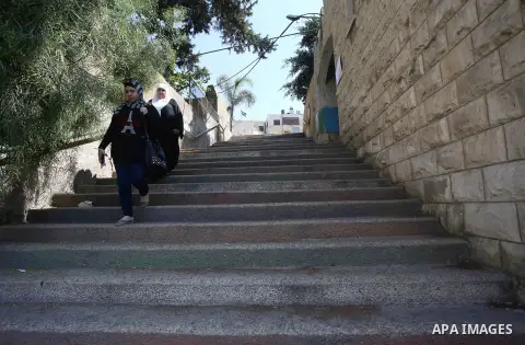 Palestinians walk down stairs to reach the markets in the Old city of the West Bank city of Nablus on August 17, 2017. Nablus city is located between two mountains where hundreds of houses are built to face the increase...