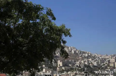 The picture taken on August 17, 2017 shows a general view of the West Bank city of Nablus. Photo by Ayman Ameen