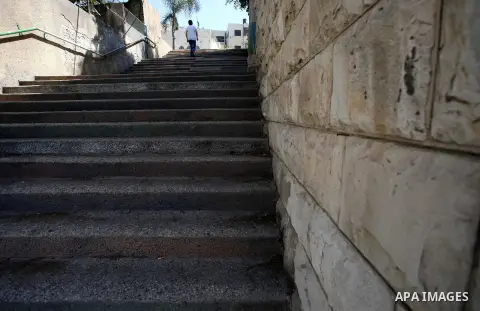A Palestinian man walks up stairs to reach the markets in the Old city of the West Bank city of Nablus on August 17, 2017. Nablus city is located between two mountains where hundreds of houses are built to face the incre...