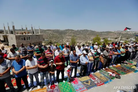 Palestinians take part in Friday prayer before a protest against alerts of the Israeli army to demolish houses, in the West Bank village of Walajeh, near Bethlehem, August 18, 2017. Photo by Wisam Hashlamoun