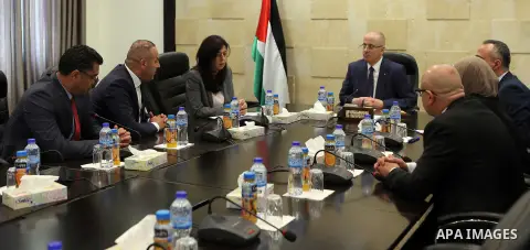 Palestinian Prime Minister, Rami Hamdallah, meets Minister of Justice Ali Abu Diak at his office, in the West Bank city of Ramallah on August 20, 2017. Photo by Prime Minister Office