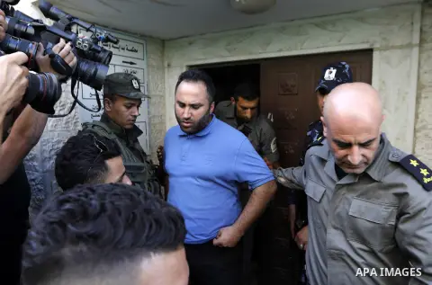 Palestinian security forces escorts Palestinian Activist Issa Amro outside a court in the West Bank city of Hebron, 07 September 2017. Issa Amro, the head of Youth Against settlements, faces charges after he wrote a post...