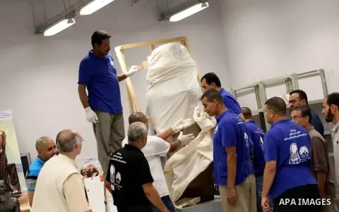 Egyptian workers transport statues upon its arrival at the restoration laboratory of the Grand Egyptian Museum (GEM) in Cairo, Egypt, on Sept. 20, 2017. A batch of statues were transported from the Egyptian Museum to the...