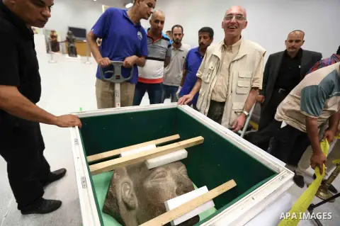 Egyptian workers transport statues upon its arrival at the restoration laboratory of the Grand Egyptian Museum (GEM) in Cairo, Egypt, on Sept. 20, 2017. A batch of statues were transported from the Egyptian Museum to the...