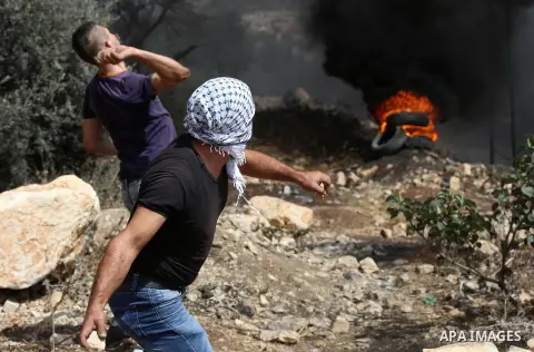 Palestinian protesters throw stones towards Israeli security forces during clashes following a demonstration against the expropriation of Palestinian land by Israel in the village of Kfar Qaddum, near Nablus in the occup...
