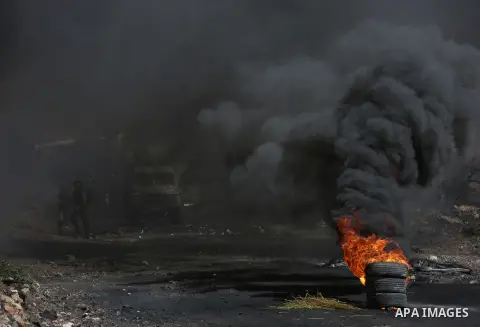 Palestinain protesters burn tires during clashes following a demonstration against the expropriation of Palestinian land by Israel in the village of Kfar Qaddum, near Nablus in the occupied West Bank, on September 22, 20...