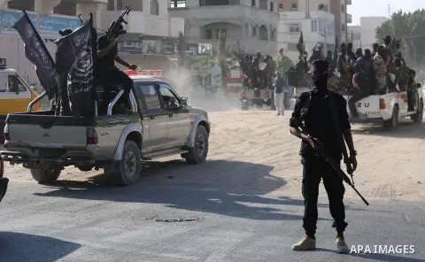 Palestinian militants from the Al-Nasser Brigades, an armed wing of the Popular Resistance Committees (PRC), take part in a military parade, in Gaza city, on September 29, 2017, to mark the 17th anniversary of the creati...