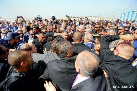 Palestinian prime minister Rami Hamdallah is surrounded by security as he arrives at the Erez border crossing in the northern Gaza Strip on October 2, 2017. Hamdallah is on on his first visit to the Gaza Strip for talks...