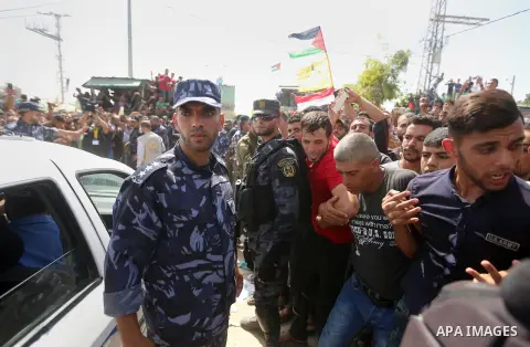 Palestinians celebrate as the convoy of Palestinian Prime Minister Rami Hamdallah and his government ministers arrive to the Erez border crossing in the northern Gaza Strip on October 2, 2017. Hamdallah is on on his firs...
