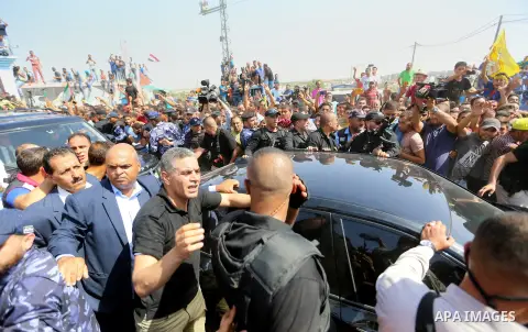 Palestinians celebrate as the convoy of Palestinian Prime Minister Rami Hamdallah and his government ministers arrive to the Erez border crossing in the northern Gaza Strip on October 2, 2017. Hamdallah is on on his firs...