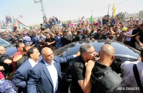 Palestinians celebrate as the convoy of Palestinian Prime Minister Rami Hamdallah and his government ministers arrive to the Erez border crossing in the northern Gaza Strip on October 2, 2017. Hamdallah is on on his firs...