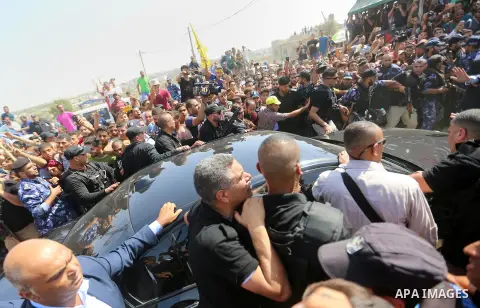 Palestinians celebrate as the convoy of Palestinian Prime Minister Rami Hamdallah and his government ministers arrive to the Erez border crossing in the northern Gaza Strip on October 2, 2017. Hamdallah is on on his firs...