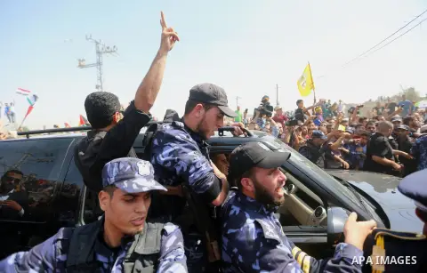 Palestinians celebrate as the convoy of Palestinian Prime Minister Rami Hamdallah and his government ministers arrive to the Erez border crossing in the northern Gaza Strip on October 2, 2017. Hamdallah is on on his firs...