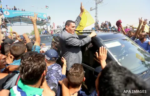 Palestinians celebrate as the convoy of Palestinian Prime Minister Rami Hamdallah and his government ministers arrive to the Erez border crossing in the northern Gaza Strip on October 2, 2017. Hamdallah is on on his firs...