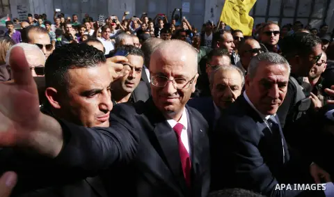 Palestinian Prime Minister Rami Hamdallah waves during his visit to the Shejaiya neighborhood in Gaza City on October 2, 2017. Palestinian prime minister Rami Hamdallah arrived in Gaza for his first visit in two years, s...