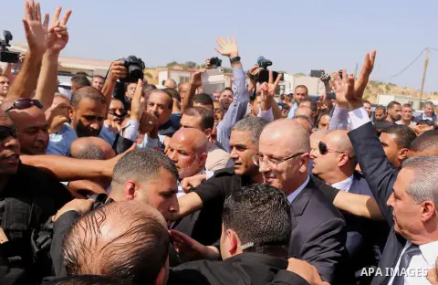 Palestinian Prime Minister Rami Hamdallah is surrounded by security following his arrival at the Erez border crossing in the northern Gaza Strip on October 2, 2017. Palestinian prime minister Rami Hamdallah arrived in Ga...