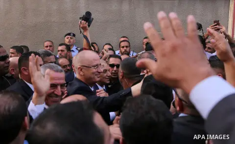 Palestinian Prime Minister Rami Hamdallah waves during his visit to the Shejaiya neighborhood in Gaza City on October 2, 2017. Palestinian prime minister Rami Hamdallah arrived in Gaza for his first visit in two years, s...