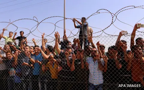 Palestinians celebrate at the Erez border crossing as Palestinian Prime Minister Rami Hamdallah's convoy arrives in the northern Gaza Strip on October 2, 2017. Palestinian prime minister Rami Hamdallah arrived in Gaza fo...