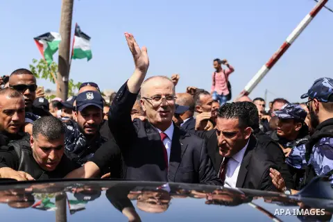 Palestinian prime minister Rami Hamdallah is surrounded by security as he arrives at the Erez border crossing in the northern Gaza Strip on October 2, 2017. Palestinian prime minister Rami Hamdallah arrived in Gaza for h...
