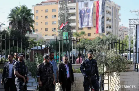 Palestinian security forces in Gaza strip stand guard as an Egyptian flag with a big poster of Palestinian President Mahmoud Abbas and Egyptian President Abdel Fattah Al-Sisi hang from a building near the Palestinian gov...