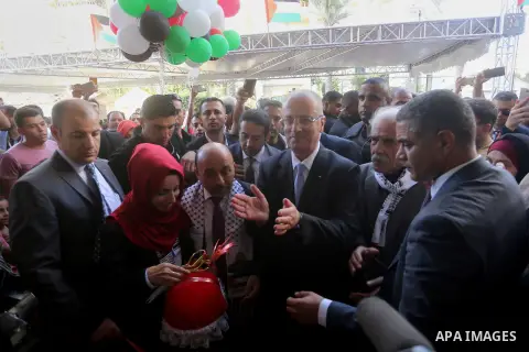 Palestinian Prime Minister Rami Hamdallah attends the opening ceremony of al-Zafer building, which was destroyed during the recent Israeli war on Gaza Strip, in Gaza city on October 3, 2017. Photo by Yasser Qudih