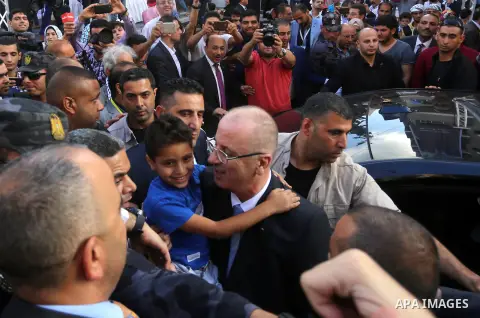 Palestinian Prime Minister Rami Hamdallah attends the opening ceremony of al-Zafer building, which was destroyed during the recent Israeli war on Gaza Strip, in Gaza city on October 3, 2017. Photo by Yasser Qudih