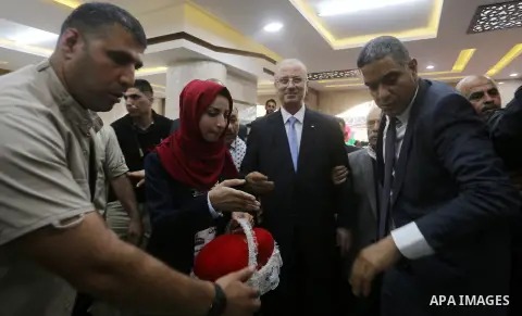 Palestinian Prime Minister Rami Hamdallah attends the opening ceremony of al-Zafer building, which was destroyed during the recent Israeli war on Gaza Strip, in Gaza city on October 3, 2017. Photo by Yasser Qudih