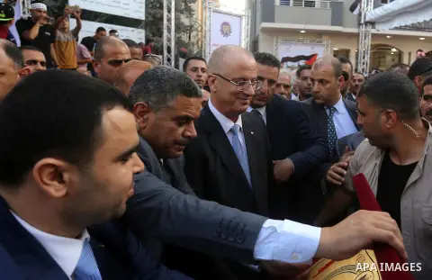 Palestinian Prime Minister Rami Hamdallah attends the opening ceremony of al-Zafer building, which was destroyed during the recent Israeli war on Gaza Strip, in Gaza city on October 3, 2017. Photo by Yasser Qudih