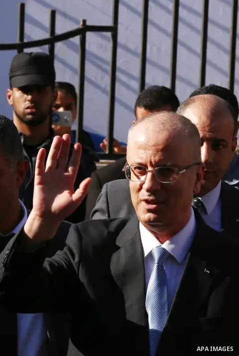 Palestinian Prime Minister Rami Hamdallah arrives before a reconciliation cabinet meeting in Gaza City on October 3, 2017. The Palestinian reconciliation government met in Gaza for the first time since 2014 as moves inte...