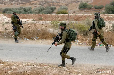 Israeli security forces take position during a protest by Palestinians demanding the reopening of the main road to the Qalqas village that was closed by Israel almost 17 years ago in the West Bank city of Hebron October...