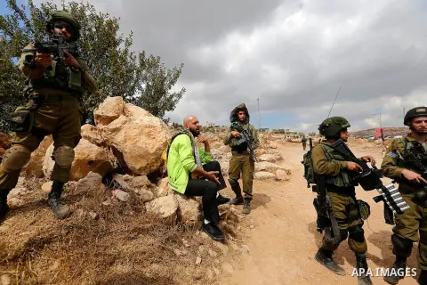 A Palestinian protester argues with Israeli security forces during a protest demanding the reopening of the main road to the Qalqas village that was closed by Israel almost 17 years ago in the West Bank city of Hebron Oc...