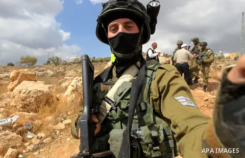 Israeli security forces take position during a protest by Palestinians demanding the reopening of the main road to the Qalqas village that was closed by Israel almost 17 years ago in the West Bank city of Hebron October...