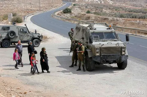 Israeli security forces take position during a protest by Palestinians demanding the reopening of the main road to the Qalqas village that was closed by Israel almost 17 years ago in the West Bank city of Hebron October...