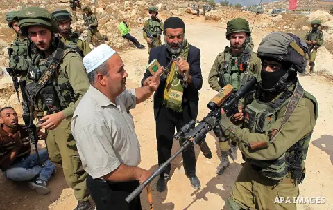 Palestinian protesters argue with Israeli security forces during a protest demanding the reopening of the main road to the Qalqas village that was closed by Israel almost 17 years ago in the West Bank city of Hebron Octo...