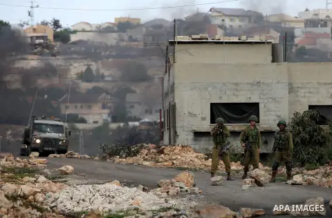 Israeli security forces take position during clashes with Palestinian protesters following a demonstration against the expropriation of Palestinian land by Israel in the village of Kfar Qaddum, near Nablus in the occupie...