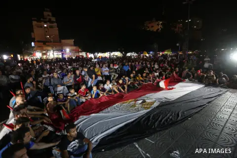 Palestinian fans watch the World Cup 2018 Africa qualifying football match between Egypt and Congo via large screens in Gaza City on October 8, 2017. Photo by Mohammed Asad