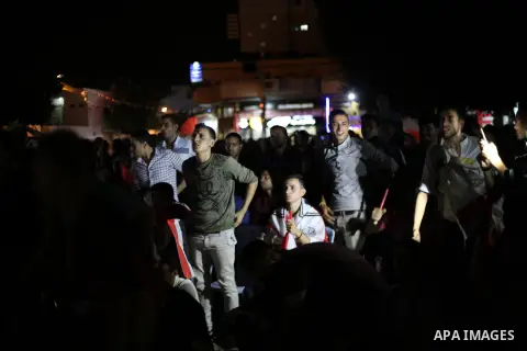 Palestinian fans watch the World Cup 2018 Africa qualifying football match between Egypt and Congo via large screens in Gaza City on October 8, 2017. Photo by Mohammed Asad