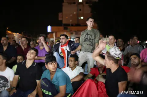 Palestinian fans watch the World Cup 2018 Africa qualifying football match between Egypt and Congo via large screens in Gaza City on October 8, 2017. Photo by Mohammed Asad