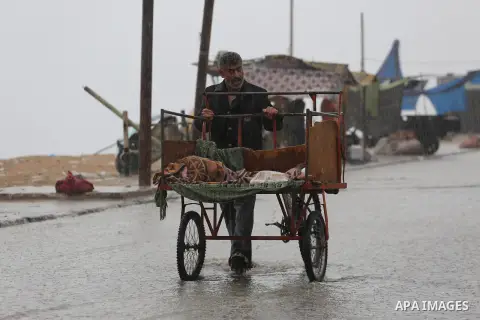 A Palestinian man rides a cart in a street flooded by rain water, in Gaza city on October 9, 2017. Photo by Mohammed Asad