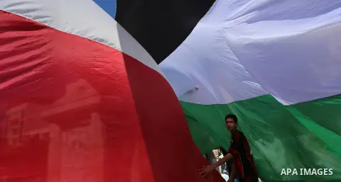 Palestinians wave the flags of Egypt, Palestine, Fatah and Hamas as they gather in Gaza City to celebrate after rival Palestinian factions Hamas and Fatah reached an agreement on ending a decade-long split following talk...
