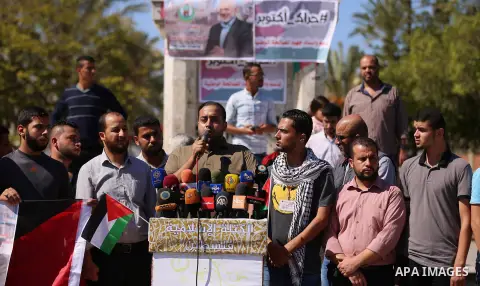 Palestinians wave the flags of Egypt, Palestine, Fatah and Hamas as they gather in Gaza City to celebrate after rival Palestinian factions Hamas and Fatah reached an agreement on ending a decade-long split following talk...