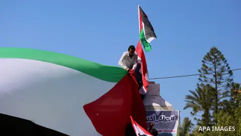 Palestinians wave the flags of Egypt, Palestine, Fatah and Hamas as they gather in Gaza City to celebrate after rival Palestinian factions Hamas and Fatah reached an agreement on ending a decade-long split following talk...
