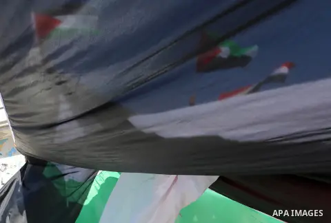 Palestinians wave the flags of Egypt, Palestine, Fatah and Hamas as they gather in Gaza City to celebrate after rival Palestinian factions Hamas and Fatah reached an agreement on ending a decade-long split following talk...