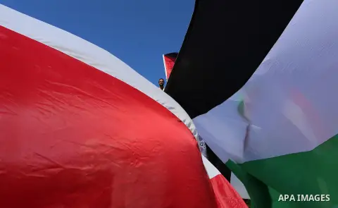 Palestinians wave the flags of Egypt, Palestine, Fatah and Hamas as they gather in Gaza City to celebrate after rival Palestinian factions Hamas and Fatah reached an agreement on ending a decade-long split following talk...