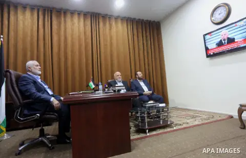 Hamas Chief Ismail Haniyeh watches a TV broadcast of a deal signing between Hamas and Fatah in Cairo, at his office in Gaza City October 12, 2017. Rival Palestinian factions Hamas and Fatah have reached agreement on aspe...