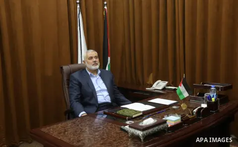 Hamas Chief Ismail Haniyeh watches a TV broadcast of a deal signing between Hamas and Fatah in Cairo, at his office in Gaza City October 12, 2017. Rival Palestinian factions Hamas and Fatah have reached agreement on aspe...