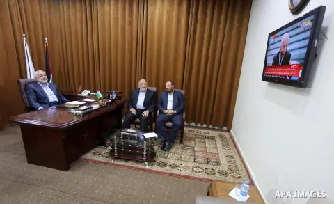 Hamas Chief Ismail Haniyeh watches a TV broadcast of a deal signing between Hamas and Fatah in Cairo, at his office in Gaza City October 12, 2017. Rival Palestinian factions Hamas and Fatah have reached agreement on aspe...